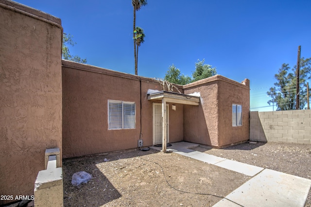 2846 N 46th Ave Unit 7, Phoenix, AZ 85035 - rear view of house with fence and stucco siding