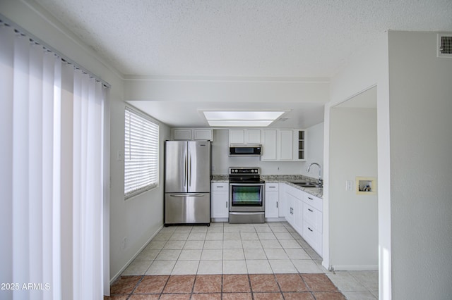 2846 N 46th Ave Unit 7, Phoenix, AZ 85035 - kitchen with stainless steel appliances, a sink, open shelves, light stone counters, and light tile patterned flooring