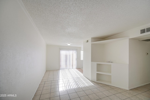 2846 N 46th Ave Unit 7, Phoenix, AZ 85035 - spare room with a textured ceiling, tile patterned flooring, and built in features