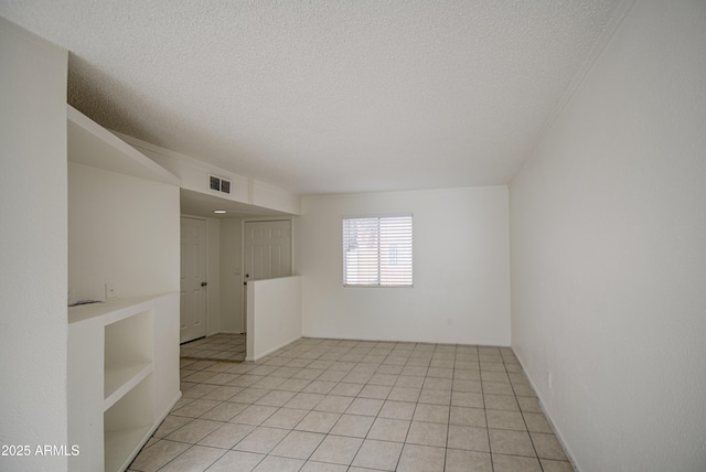 2846 N 46th Ave Unit 7, Phoenix, AZ 85035 - empty room with a textured ceiling and light tile patterned floors