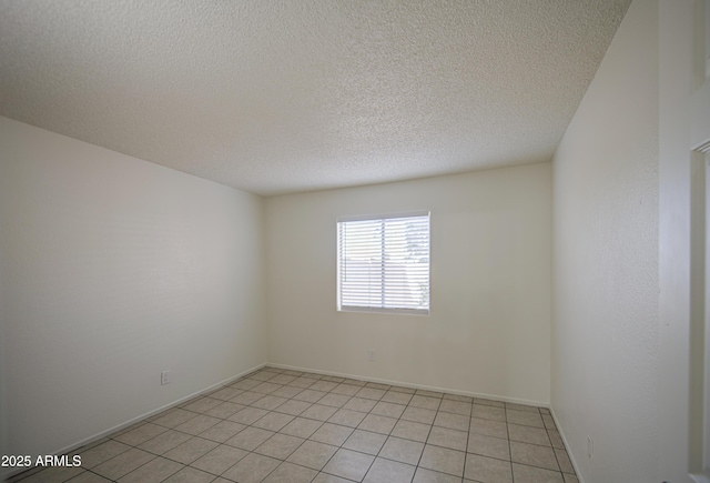 2846 N 46th Ave Unit 7, Phoenix, AZ 85035 - empty room with a textured ceiling, light tile patterned flooring, and baseboards