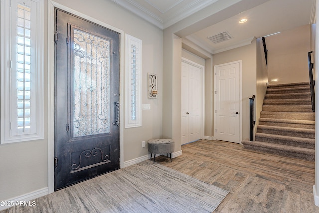 foyer with crown molding and wood-type flooring