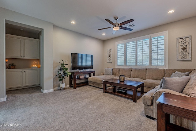 carpeted living room featuring ceiling fan