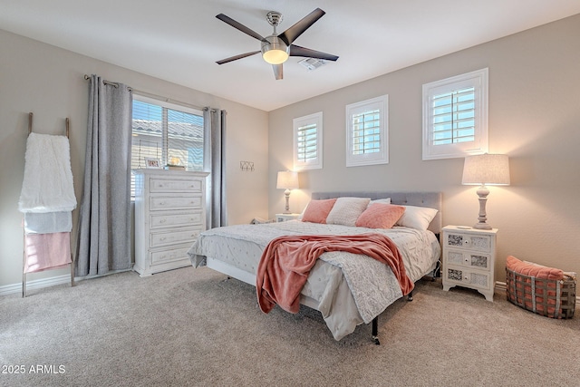 carpeted bedroom featuring ceiling fan and multiple windows