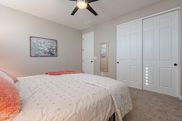 carpeted bedroom with ceiling fan and a closet