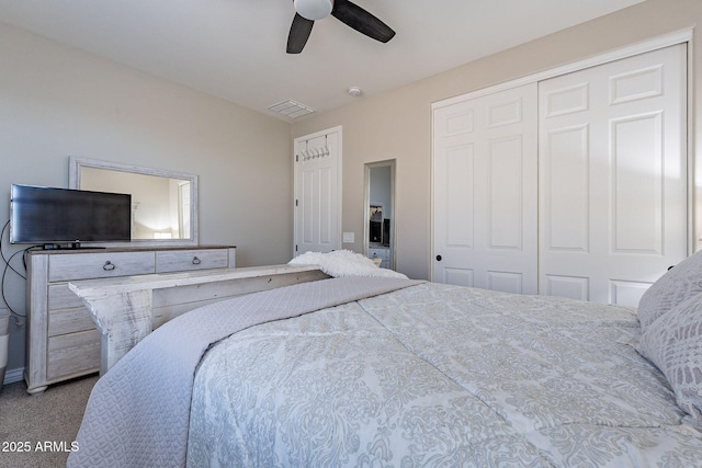 carpeted bedroom featuring ceiling fan and a closet