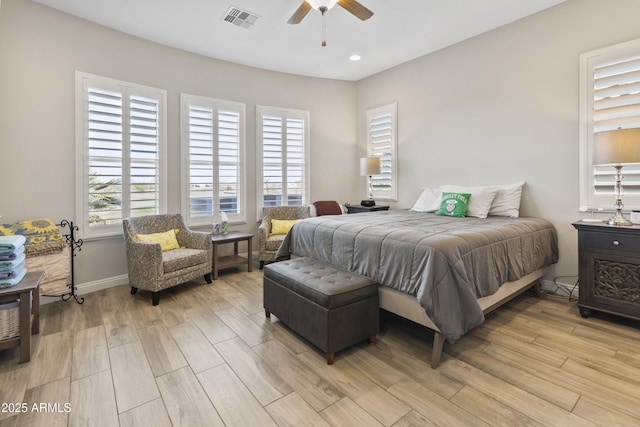 bedroom featuring light wood-type flooring, baseboards, visible vents, and a ceiling fan