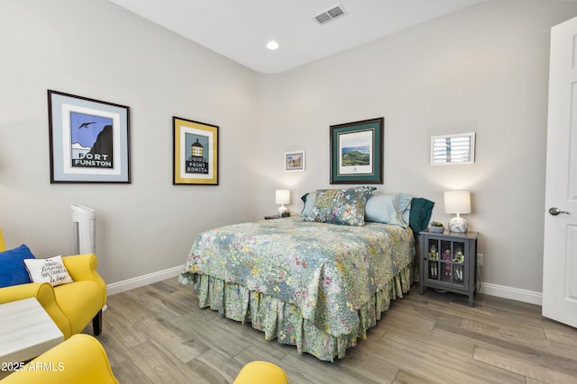 bedroom with baseboards, visible vents, wood finished floors, and recessed lighting