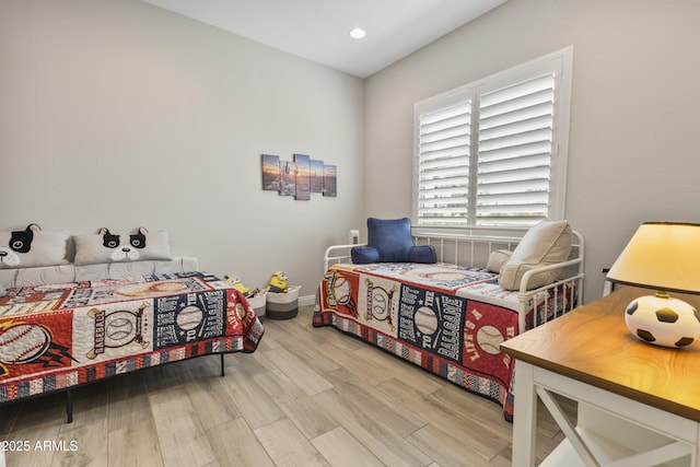 bedroom featuring wood finished floors and recessed lighting