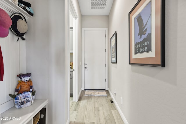 entryway featuring visible vents, light wood-style flooring, and baseboards