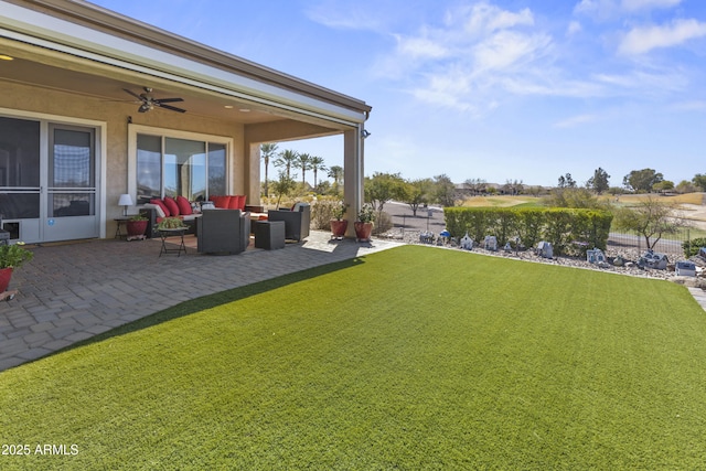 view of yard with a patio area, ceiling fan, an outdoor hangout area, and fence