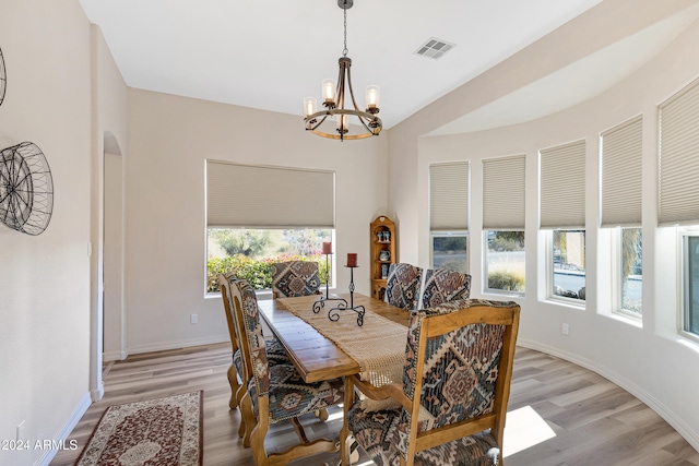 dining room featuring an inviting chandelier, plenty of natural light, and light hardwood / wood-style flooring