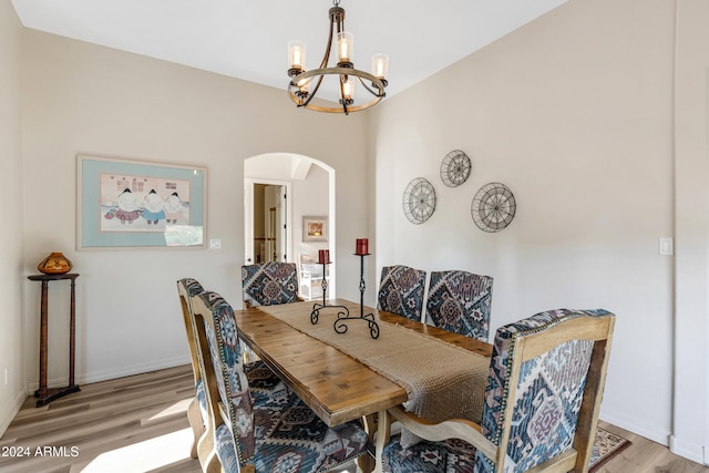 dining area featuring light hardwood / wood-style floors and a notable chandelier