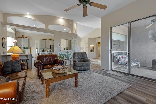 living room with ceiling fan, wood-type flooring, and high vaulted ceiling