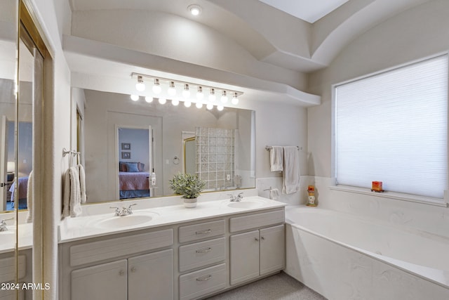 bathroom with a washtub and vanity