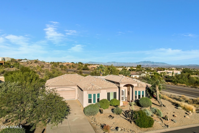 mediterranean / spanish-style home featuring a mountain view and a garage