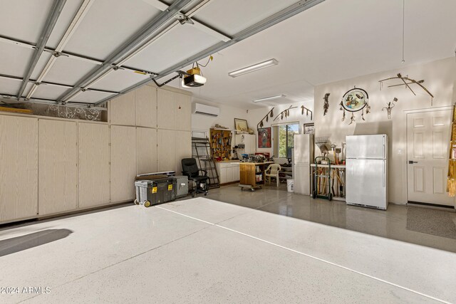 garage with a garage door opener, a wall unit AC, and white fridge