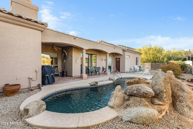 view of swimming pool with ceiling fan and a patio