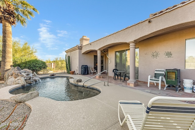 view of swimming pool featuring pool water feature and a patio area