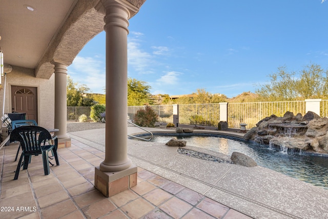 view of patio with pool water feature and a fenced in pool