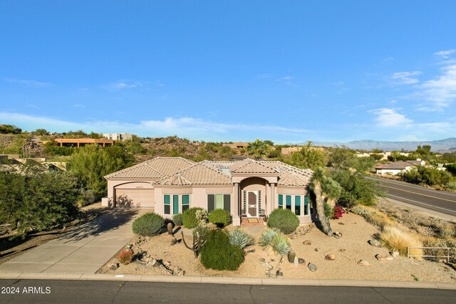 view of front of home featuring a mountain view and a garage