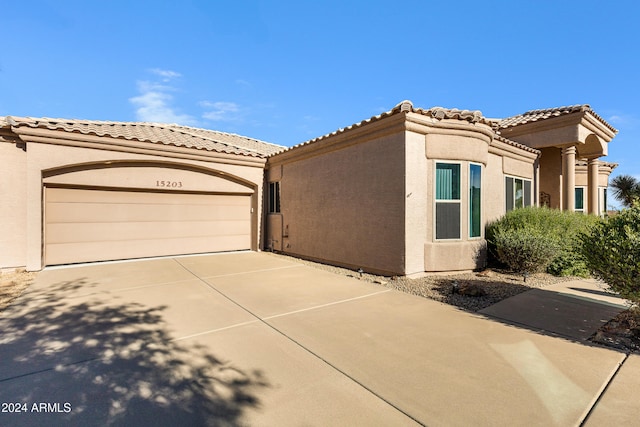 mediterranean / spanish-style house with a garage