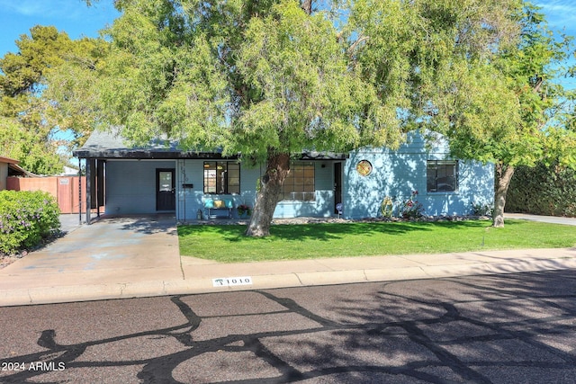 view of front of house with a front lawn and a carport