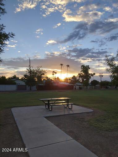 view of community with a yard and a patio