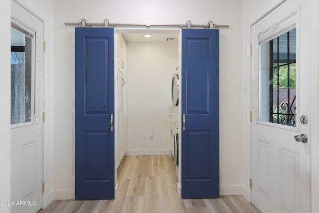 entryway featuring a barn door and light hardwood / wood-style flooring