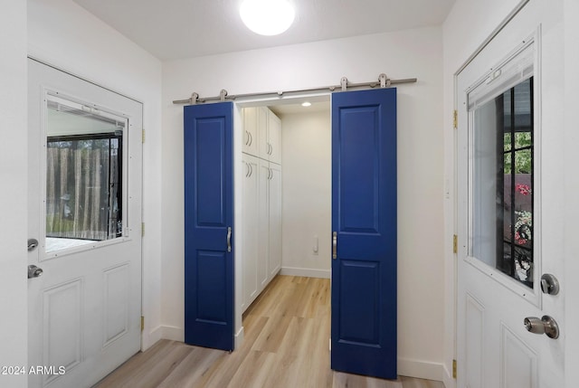 interior space featuring a barn door and light hardwood / wood-style floors