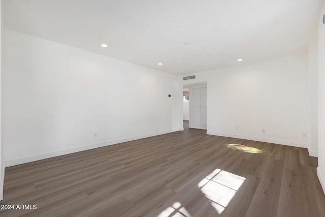 spare room with dark wood-type flooring