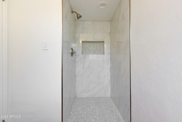 bathroom with tiled shower