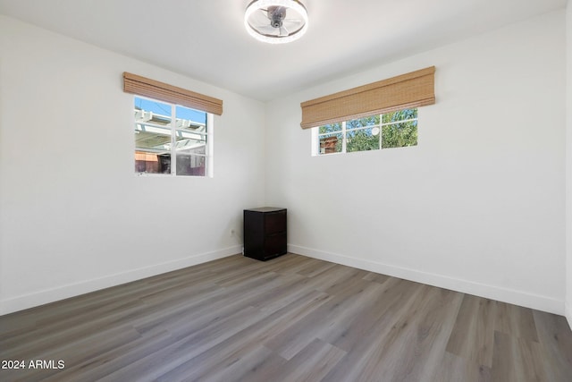 unfurnished room with plenty of natural light and hardwood / wood-style flooring