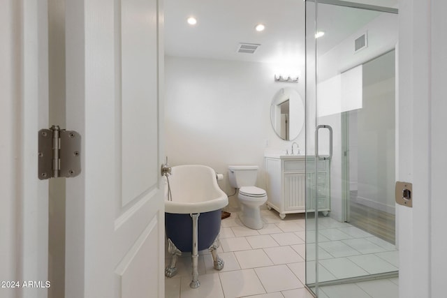 bathroom featuring tile patterned flooring, toilet, and a tub