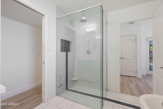 bathroom with tile patterned flooring and a shower with shower door