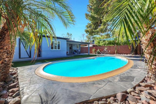 view of swimming pool featuring a patio area