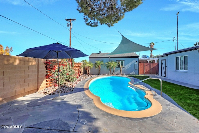 view of swimming pool with an outbuilding and a patio