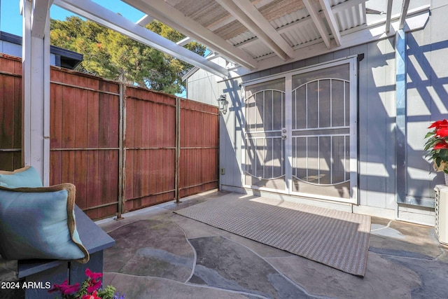 view of gate with a patio area