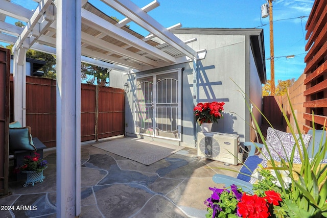 view of patio / terrace featuring a pergola and ac unit