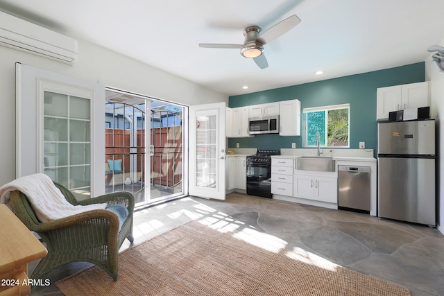 kitchen with white cabinets, sink, appliances with stainless steel finishes, and a wall mounted AC