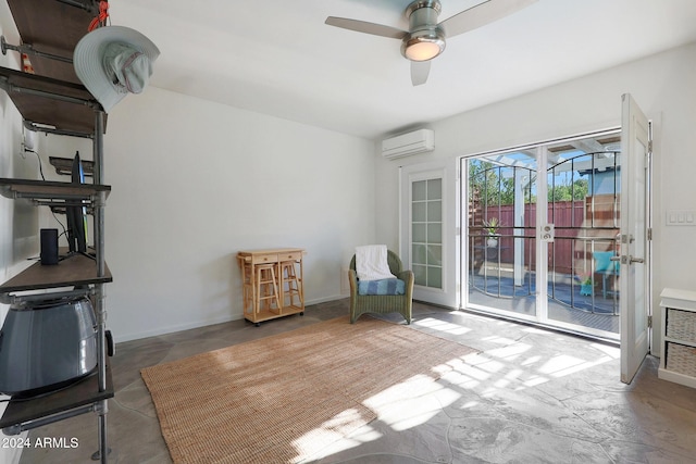 sitting room with a wall mounted air conditioner and ceiling fan