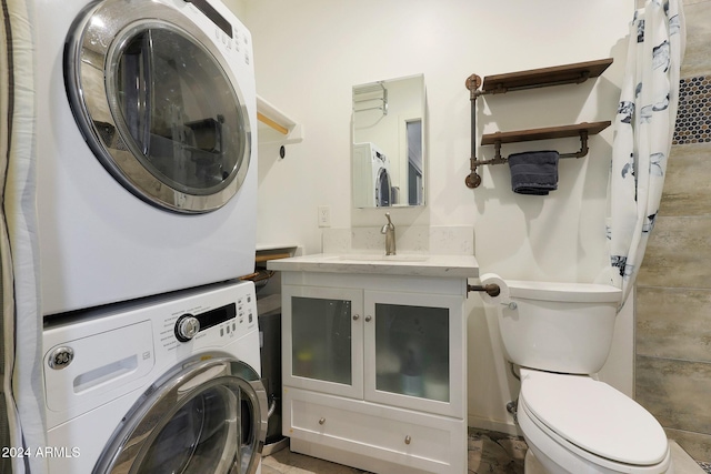 laundry room featuring stacked washing maching and dryer and sink