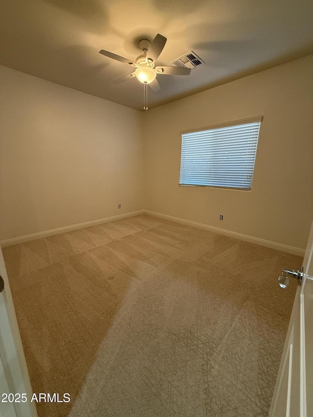 carpeted empty room featuring ceiling fan