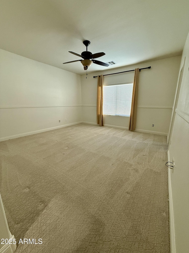 spare room featuring ceiling fan and carpet