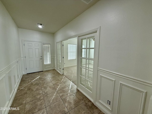 tiled foyer entrance with french doors