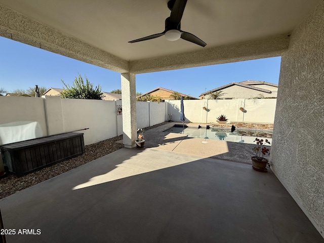 view of patio / terrace featuring ceiling fan and a fenced in pool