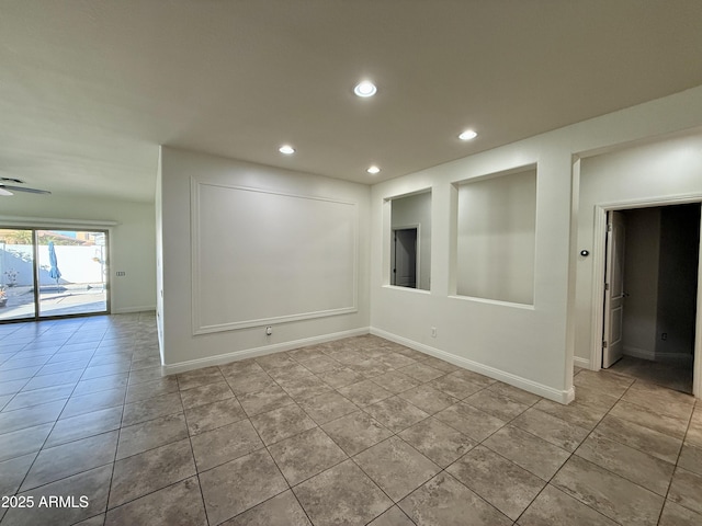 unfurnished room with light tile patterned flooring and ceiling fan