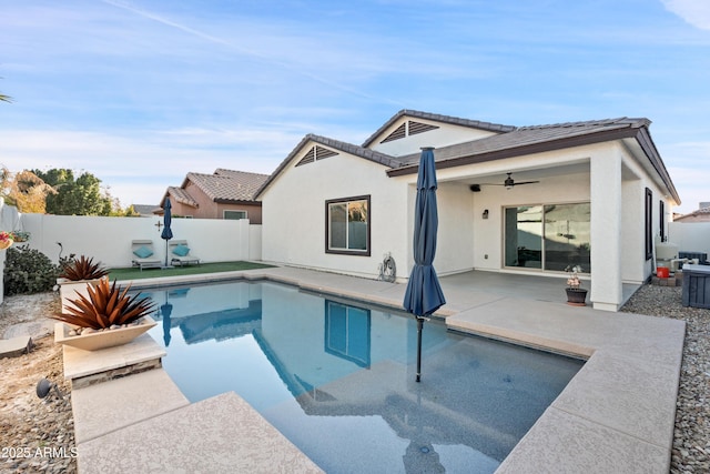 view of swimming pool featuring ceiling fan and a patio