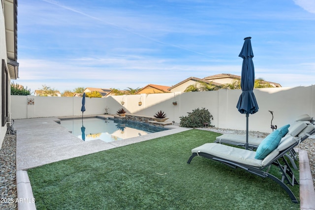 view of pool with a yard and a patio area