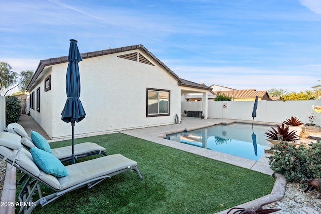 view of swimming pool with a yard and a patio area